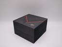 Closed original Raymond Weil watch box in black with a red and gold "RW" logo.