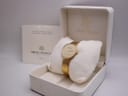 The Michel Herbelin watch resting in its original white box, with accompanying papers visible in the background.