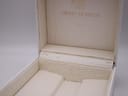 Close-up of the interior of the vintage Michel Herbelin watch box, showing significant cracking and wear to the white lining.