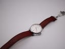 Top-down view of the Certina DS Podium with the brown leather strap unfurled, showing the deployant clasp.