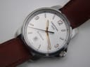 Angled close-up of the Certina DS Podium dial, highlighting the white face, Arabic numerals, and dauphine hands.