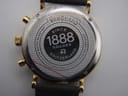 Close-up of the watch case back, revealing "VANGUARD", "SINCE 1888 ROAMER SWITZERLAND", "5 ATM WATER RESISTANT", "SAPPHIRE CRYSTAL", and serial "935 951". Protective film is visible.