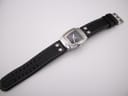 Full length view of the Hamilton H163110 watch with its black leather strap extended.