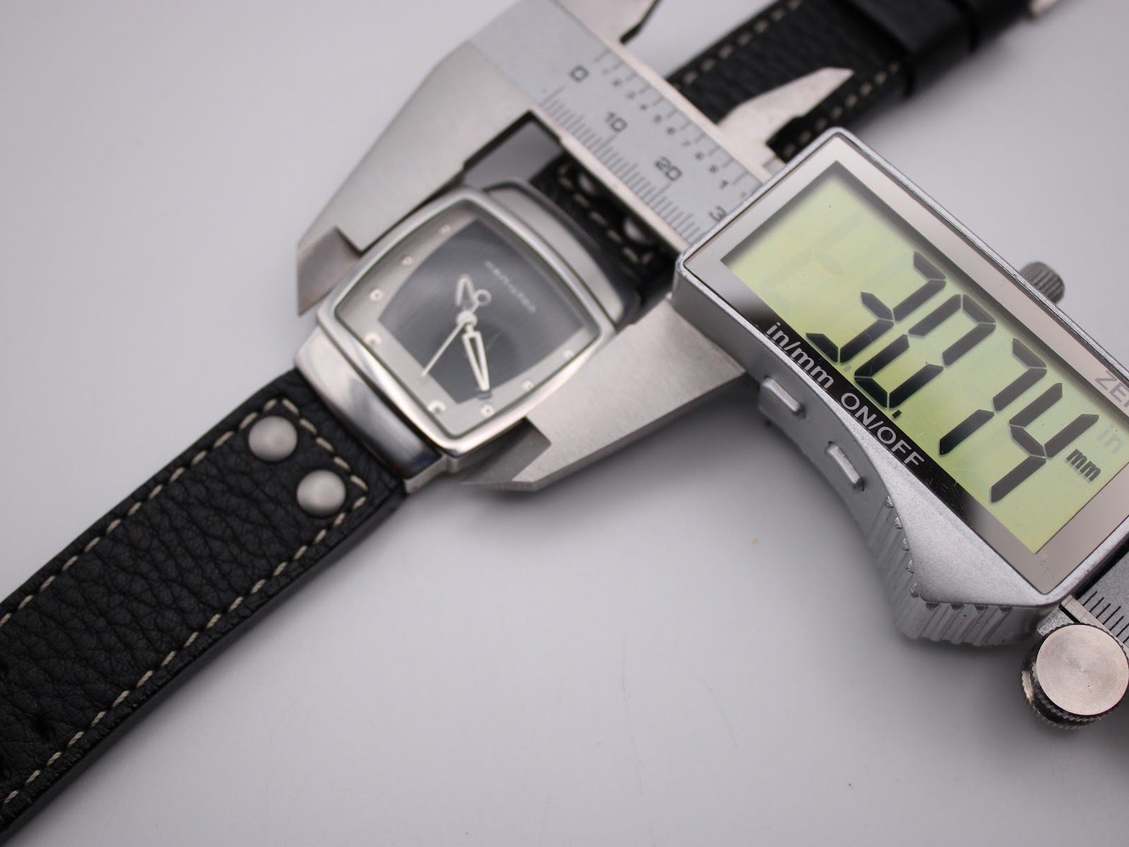 Digital caliper measuring the case width of the Hamilton H163110 at 30.74mm.