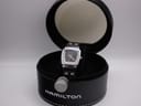 Hamilton H163110 quartz watch in original black leatherette box with white stitching and transparent lid.