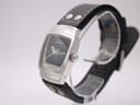 Angled side view of Hamilton H163110 watch, showing crown detail and curved tonneau case on a display stand.