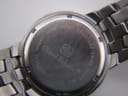 Close-up of the watch case back, showing 'Gianni Sabatini', 'ALL STAINLESS STEEL', '100M WATER RESISTANT', 'SWISS MOVT', and model number NGS403.