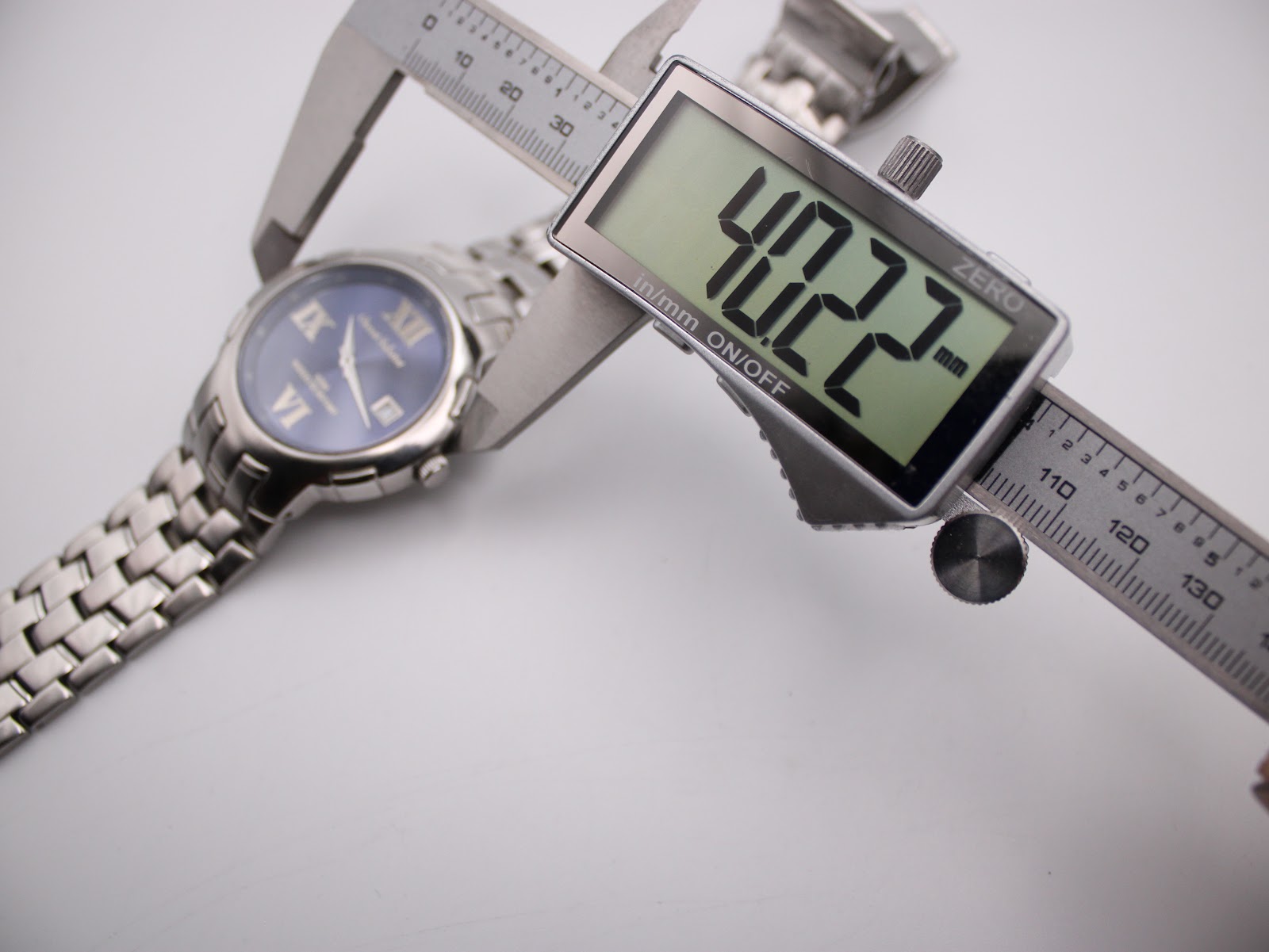 Digital caliper measuring the watch case diameter at 40.22mm.