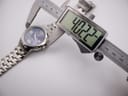 Digital caliper measuring the watch case diameter at 40.22mm.