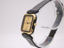 Angled side view of the Certina Ibiza watch on a stand, highlighting the gold case profile and crown