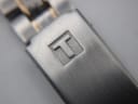 Overhead angled view of the Tissot PR 50 watch, showcasing the full two-tone bracelet.