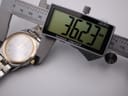 Tissot PR 50 watch bracelet on a wrist sizing gauge, showing a circumference measurement of 203mm.