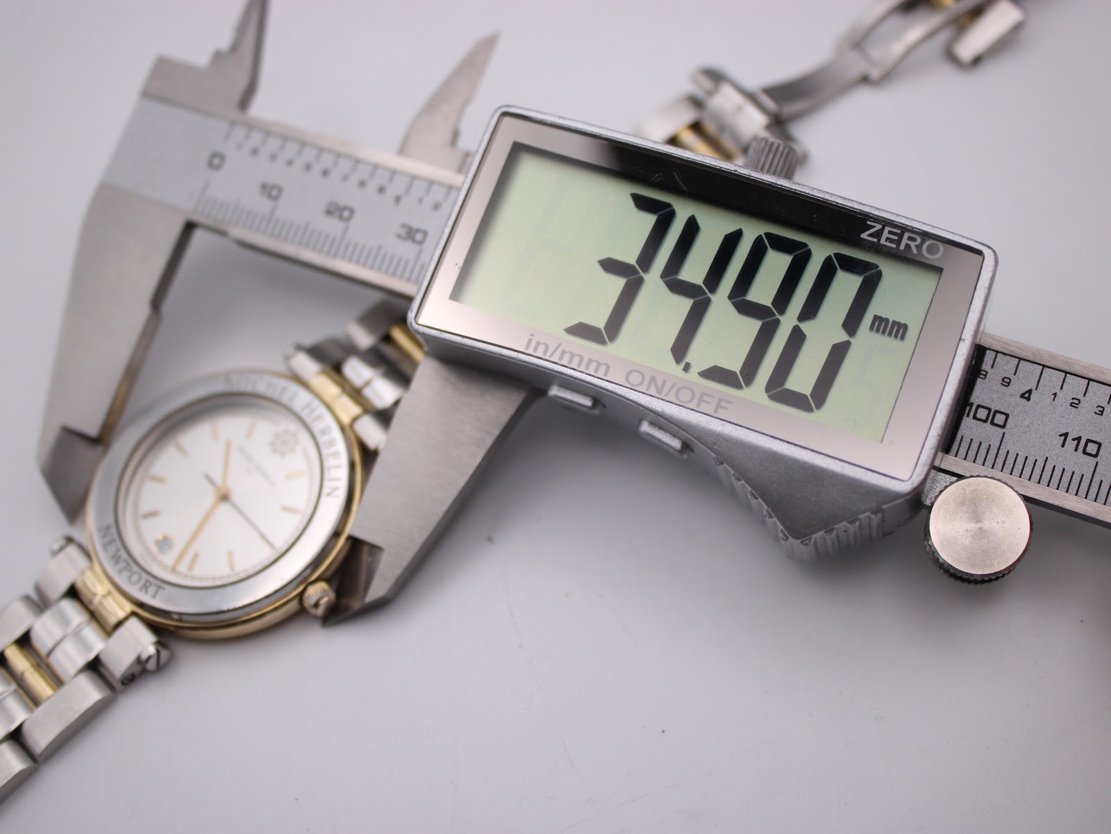 Digital caliper measuring the Michel Herbelin watch case diameter precisely at 34.90mm.