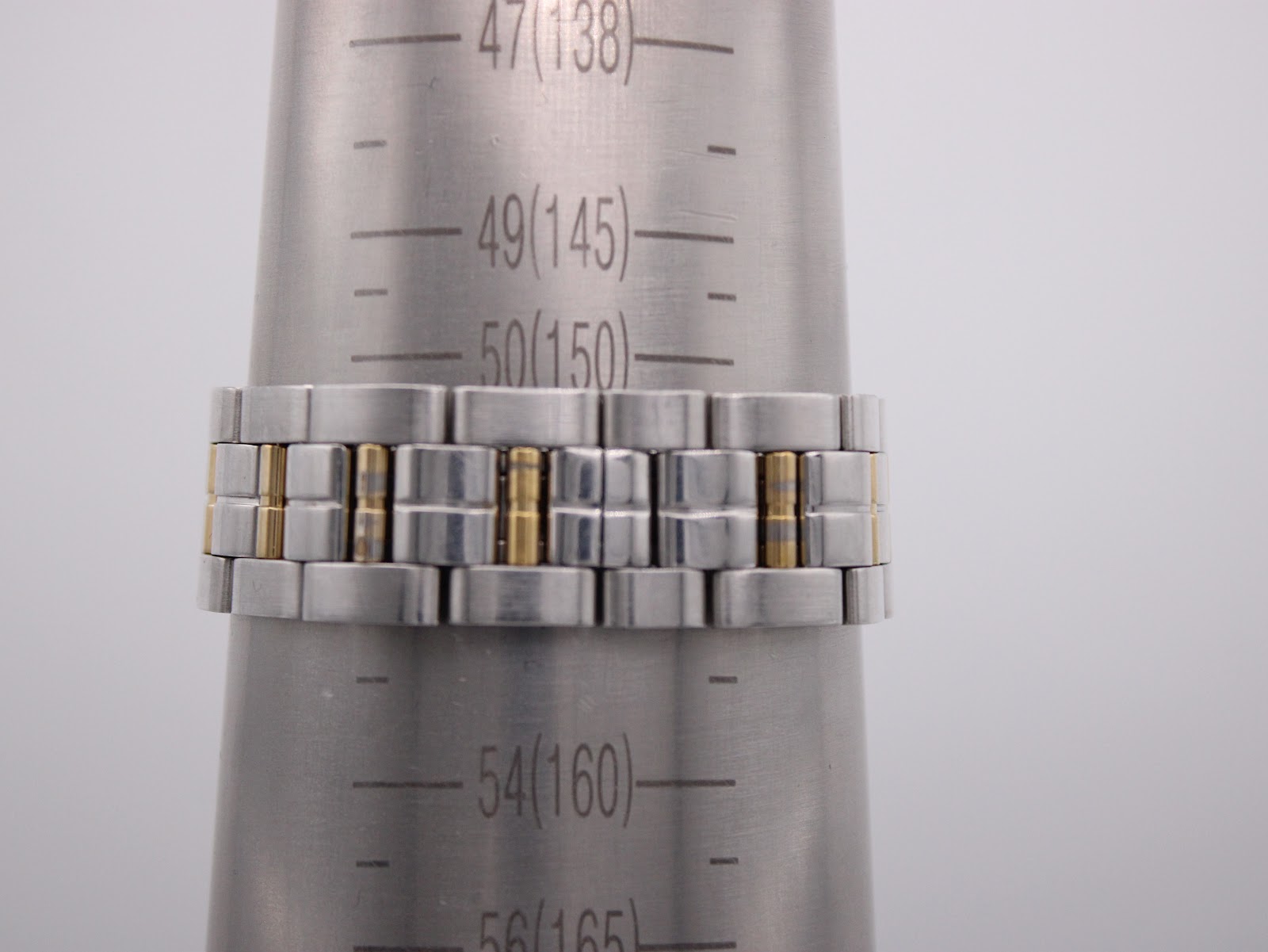 Watch bracelet on a sizing cone, showing a wrist circumference measurement of approximately 150mm (15cm).
