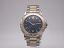 Front view of the Michel Herbelin Newport two-tone watch, showcasing its deep blue dial with gold-tone indices and ship's wheel logo.