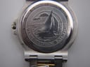 Close-up of the stainless steel case back of the Michel Herbelin Newport, featuring an intricate sailboat engraving, 'Newport', '50m' water resistance, and 'ETA Swiss Movt'.