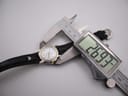 Close-up of a digital caliper measuring the case diameter of the Michel Herbelin watch at 26.93mm.
