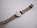 Full length back view of the Michel Herbelin watch, showing the case back and the underside of the Maurice Lacroix strap.