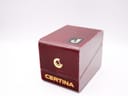 Closed view of the original Certina watch box, a red textured box with gold Certina logo and text on the front.