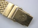 Close-up of the gold-tone fold-over clasp on the mesh bracelet, featuring the embossed Certina 'double C' logo.