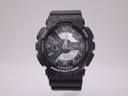 Front view of black Casio G-Shock GA-110C watch with ana-digi dial, white hands, and digital displays.