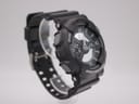 Angled side view of black Casio G-Shock GA-110C watch, highlighting the "ADJUST" and "MODE" buttons.