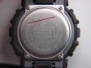 Close-up of the stainless steel case back of the G-Shock GA-110C, showing "SHOCK RESIST", "WATER RESIST 20BAR", and model number.