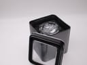 Casio G-Shock GA-110C watch sitting in an open black metal tin with a clear lid.