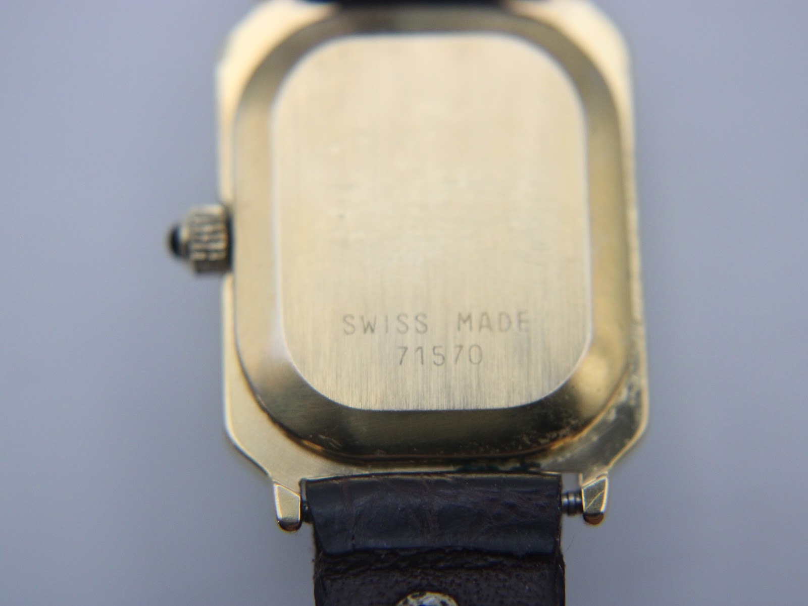 Close-up of the watch case back, engraved with 'Swiss Made' and the model number '71570'.