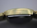 Close-up of the watch case side, showing engraved text 'GOLDPLATED G10 MICRONS' and 'FRANCE'.