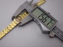 Digital caliper measuring the width of the watch case, showing a precise measurement of 15.67mm.