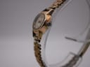 Side profile of the Rotary watch on a clear stand, showing the crown and case shape.