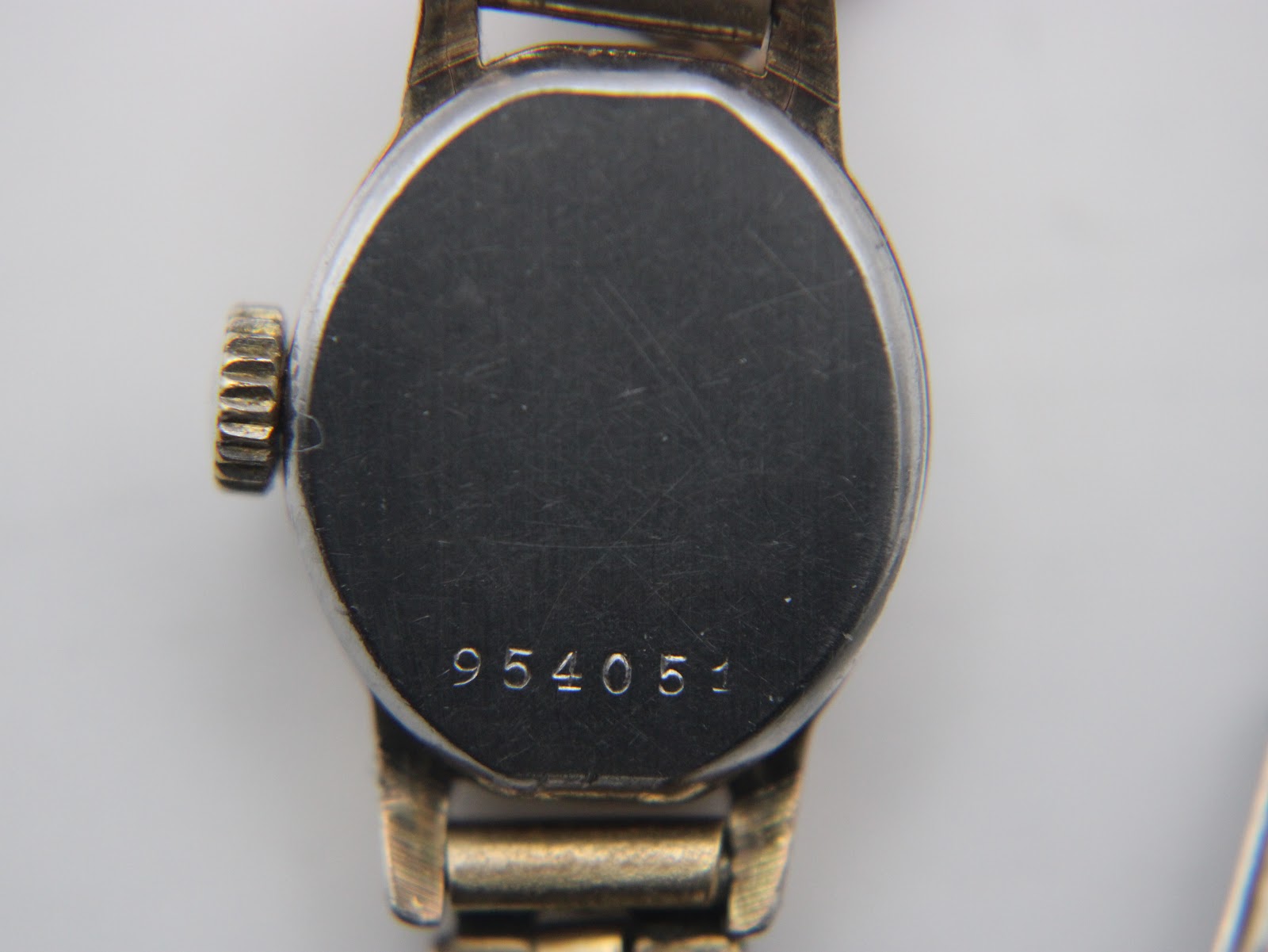 Close-up of the watch case back showing the serial number 954051.