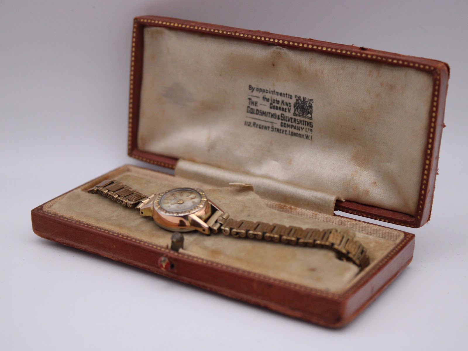 The Rotary watch nestled inside its original vintage Goldsmiths & Silversmiths presentation box, open view.