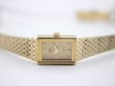 Direct close-up of the champagne rectangular dial, showing 'ROTARY QUARTZ JAPAN' and gold baton indices with Roman XII.