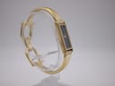 Angled view of Gucci 1500L watch on a clear display stand, showing the opposite side of the case and bracelet connection.