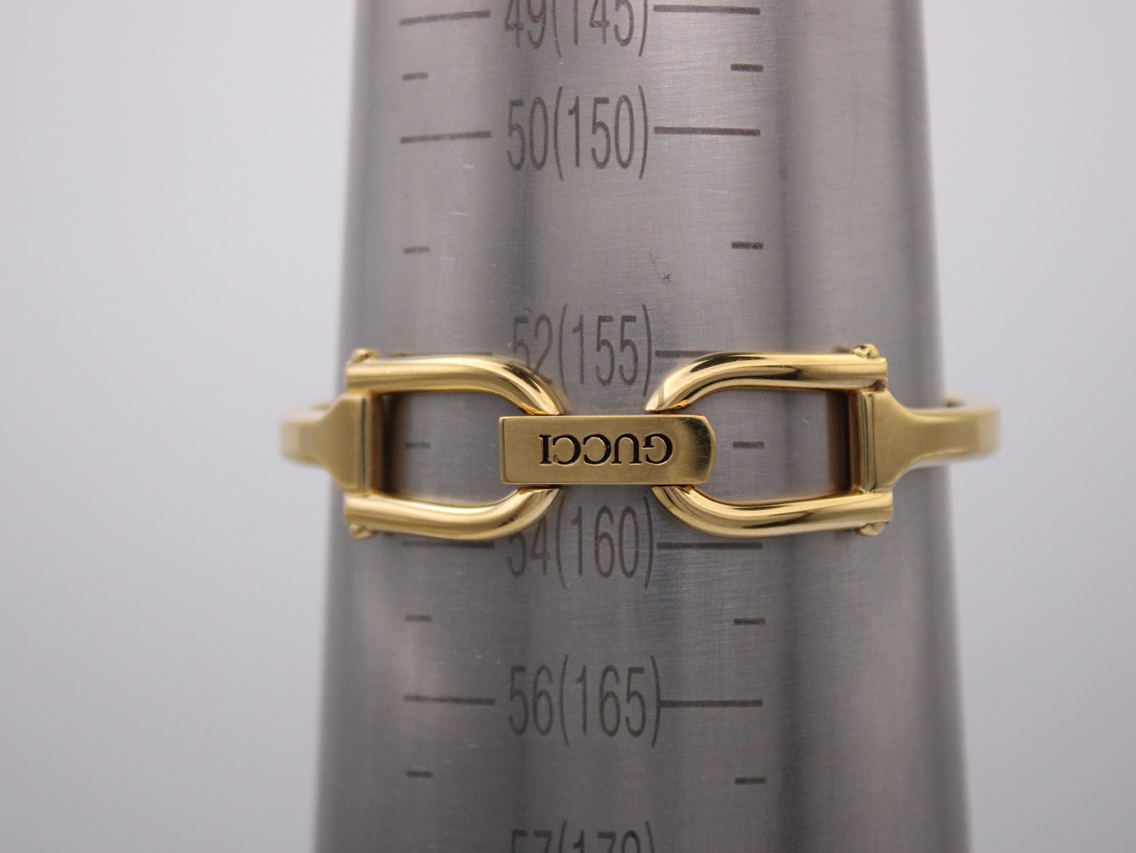 Wrist sizing gauge showing the integrated bangle bracelet, indicating a wrist size of approximately 155mm (15.5cm).