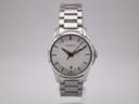 Front-on view of the Gucci 126.5 watch with silver dial and stainless steel bracelet against a white background.