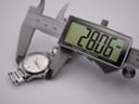 Digital caliper measuring the case diameter of the Gucci 126.5 watch, displaying a precise measurement of 28.06mm.