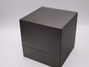 Closed original dark brown Gucci watch box with embossed logo on the lid.