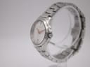 Angled side view of the Gucci 126.5 watch on a clear stand, showing the case profile and signed crown.