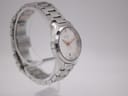 Opposite angled side view of the Gucci 126.5 watch on a clear stand, highlighting the bracelet links.