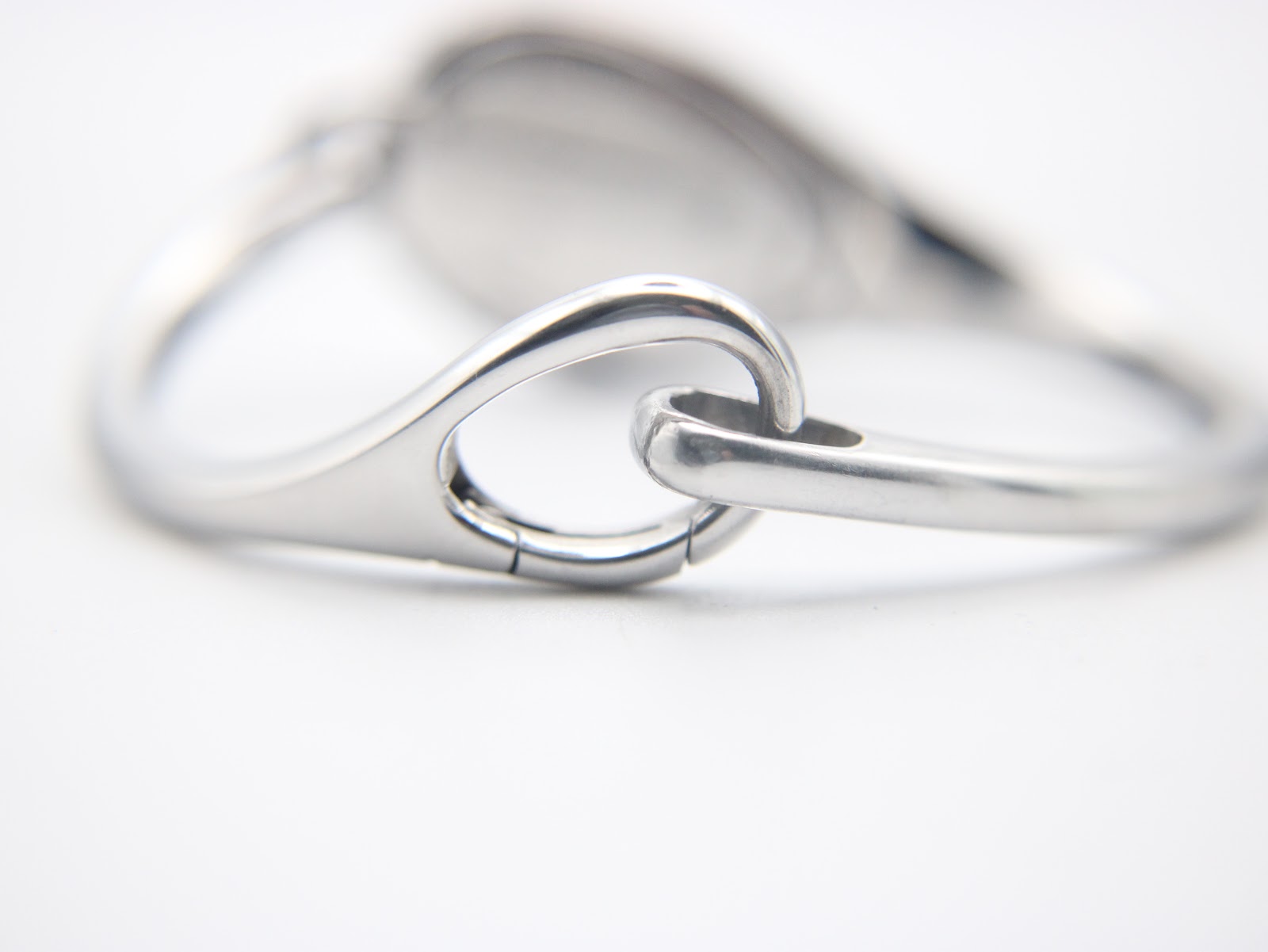 Close-up of the hidden clasp mechanism on the integrated silver bracelet.
