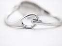 Close-up of the hidden clasp mechanism on the integrated silver bracelet.