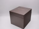 Front view of the closed brown Gucci presentation box with the gold 'GUCCI' logo.