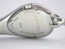 Close-up of the watch case back, engraved with 'STAINLESS STEEL', 'GUCCI', '103', 'SWISS MADE', and 'WATER RESISTANT 3 ATM'.