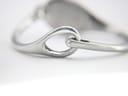 Close-up of the integrated bangle clasp mechanism, a simple yet elegant hook-and-eye design.