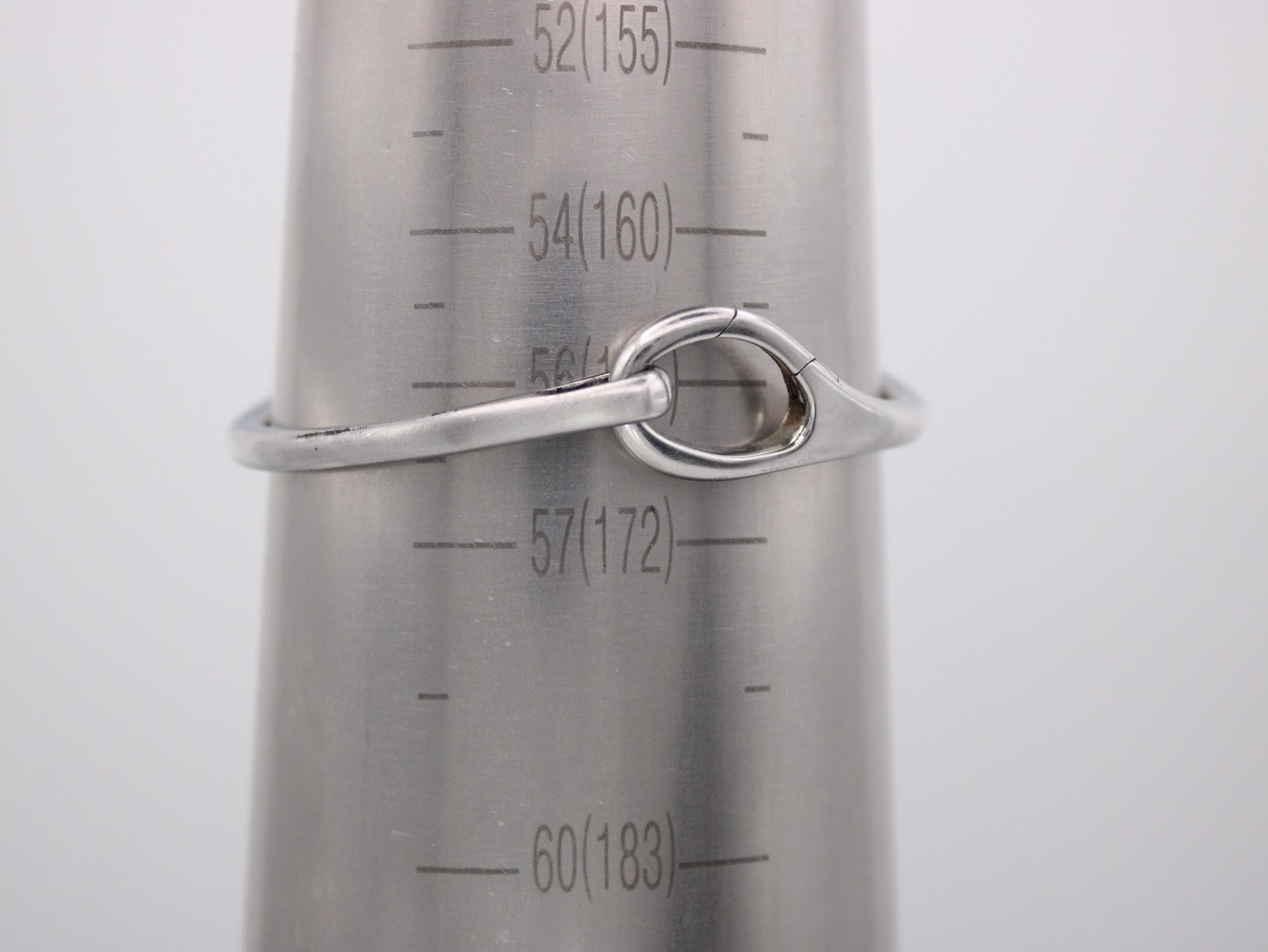 The Gucci watch bangle closed on a wrist sizing cone, indicating a circumference measurement of approximately 160mm (16cm).