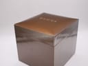 Top-down view of the closed original brown Gucci presentation box with the gold 'GUCCI' logo embossed on the lid.