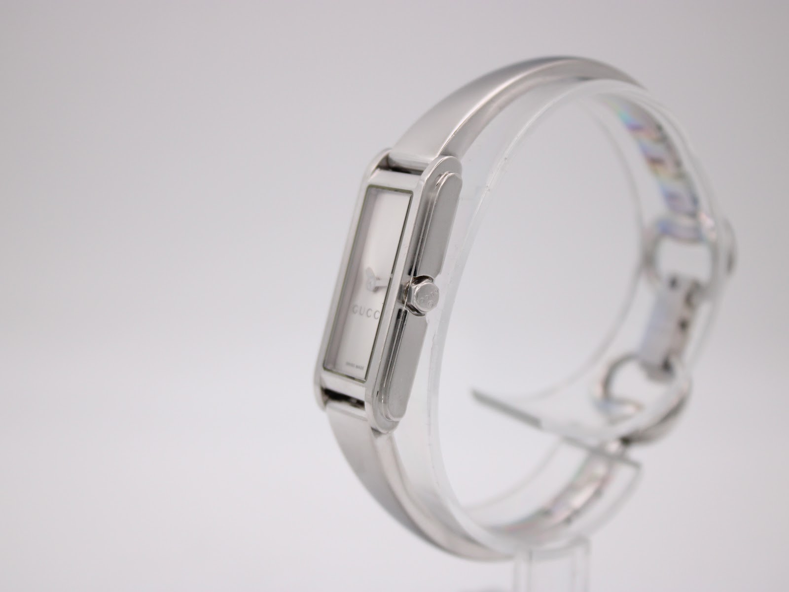 Angled side view of the Gucci 109 watch, showcasing the crown and integrated bracelet design.